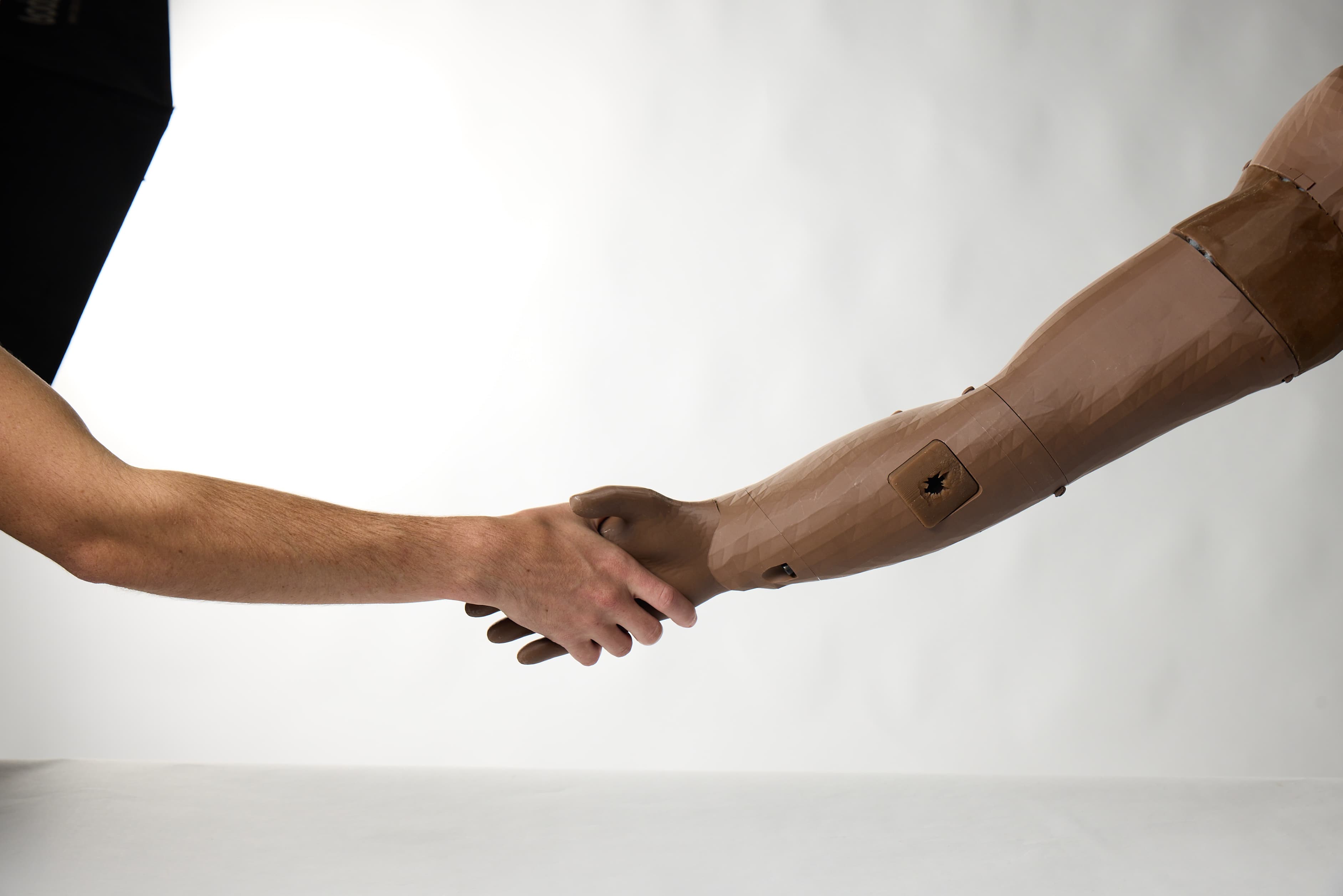 A handshake between a person and the RDMT arm trainer